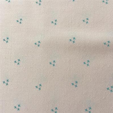 Turquoise crosstitch on pale pink fabric